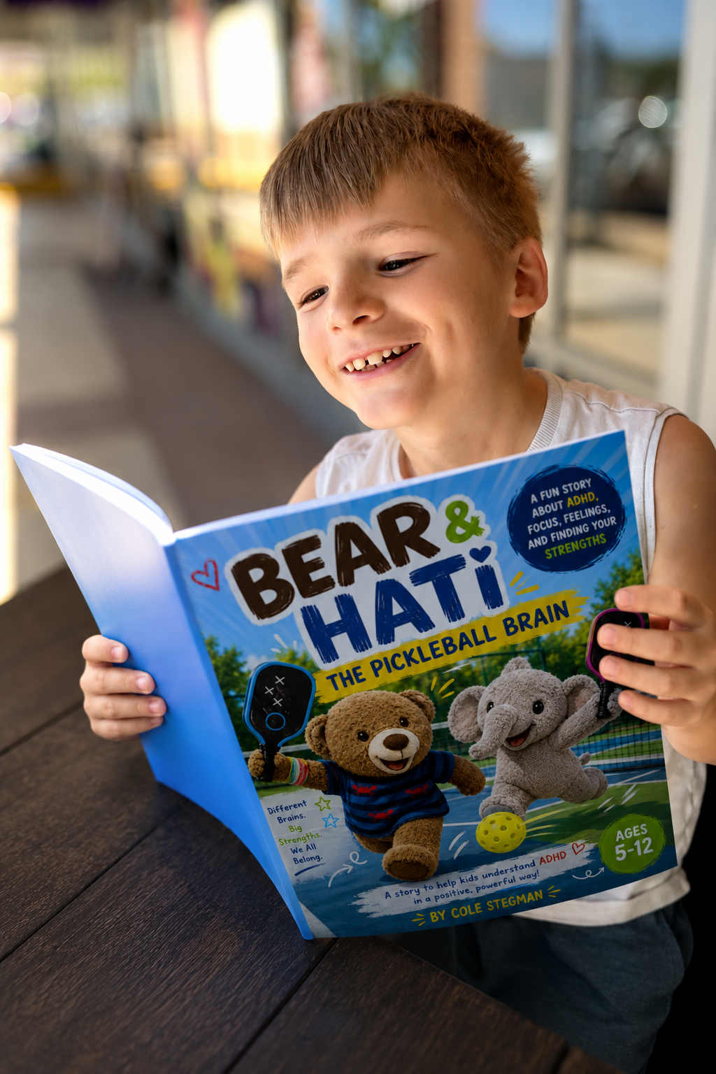 Brecken holding The Pickleball Brain — Bear and Hati ADHD children's book for kids ages 5 to 12